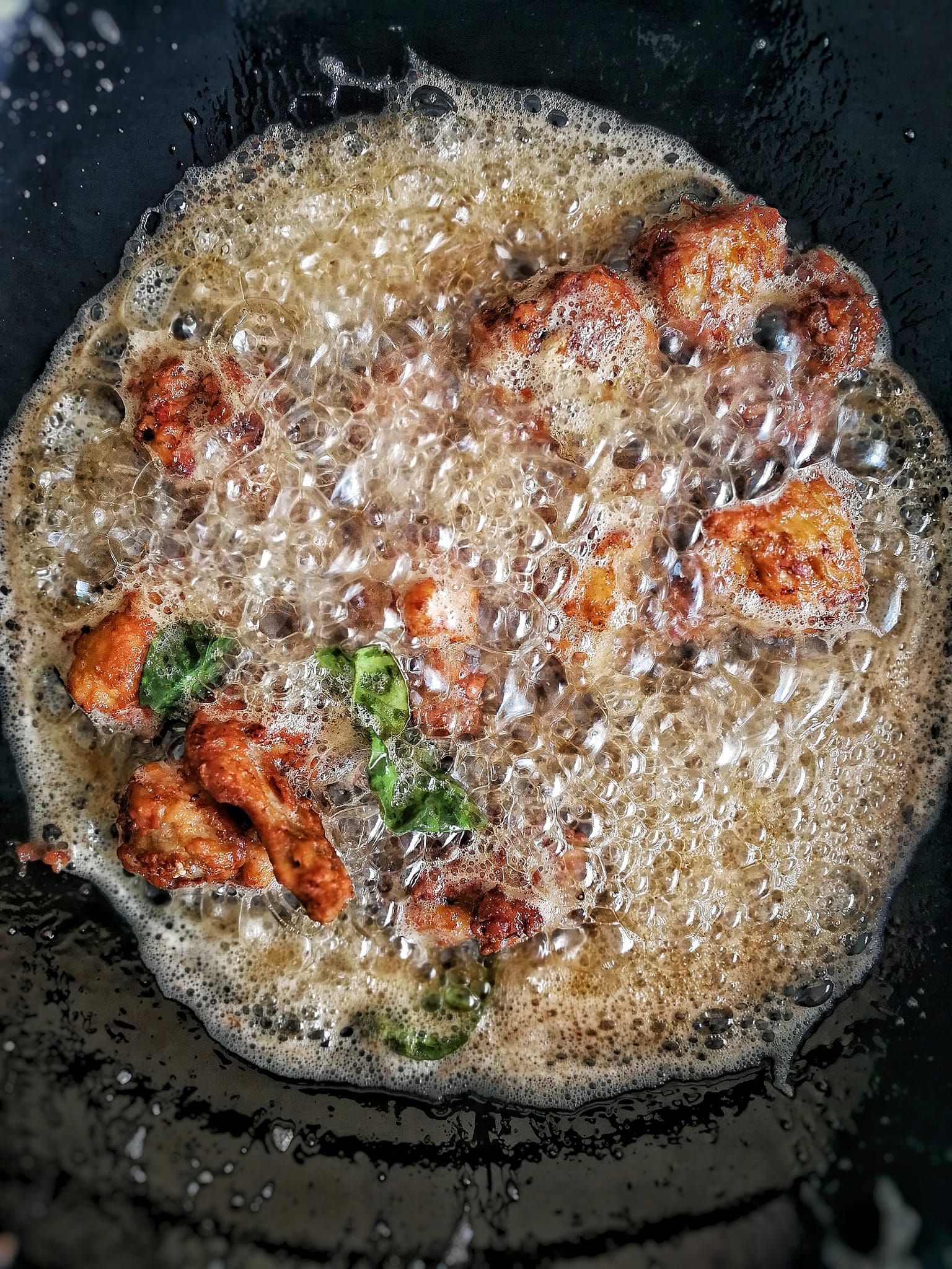 Fried chicken wings in the boiling oil